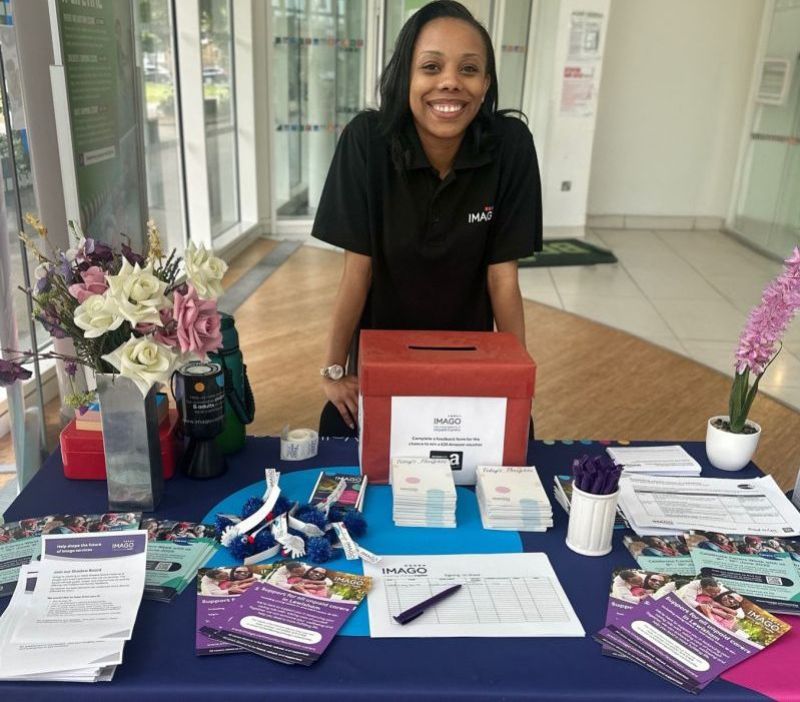 Imago staff member welcoming someone to a carers event